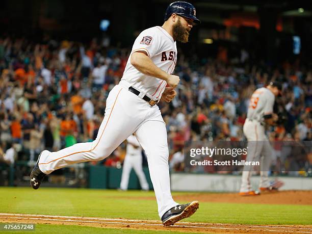 Evan Gattis of the Houston Astros runs to first base after hitting a three-run home run in the third inning off Mike Wright of the Baltimore Orioles...