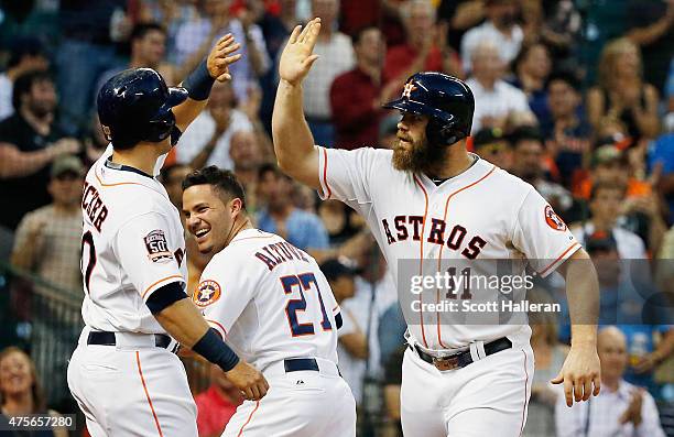 Evan Gattis of the Houston Astros is greeted by Preston Tucker after Gattis hit a three-run home run in the third inning during their game against...