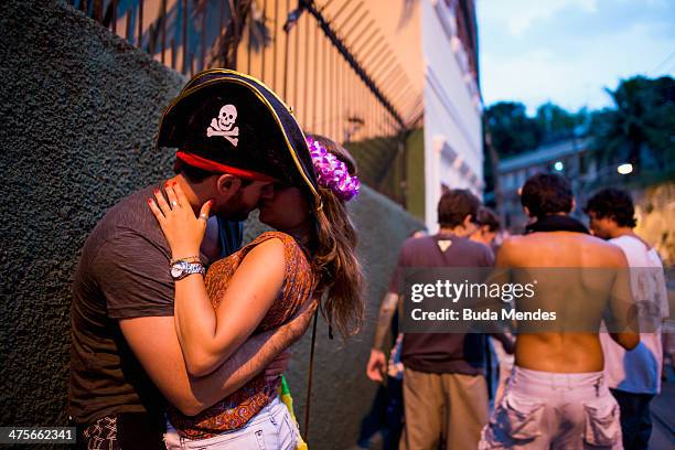 Couple kiss during the parade of Bloco Das Carmelitas at the Street carnival celebration at Santa Tereza Neighbourhood on February 28, 2014 in Rio de...