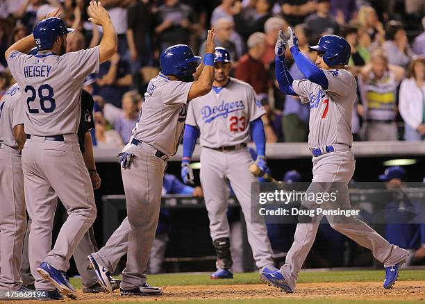 Alex Guerrero of the Los Angeles Dodgers celebrates his game winning grand slam off of Rafael Betancourt of the Colorado Rockies with Alberto...