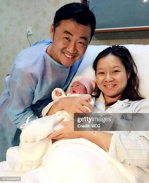 Retired Chinese tennis star Li Na poses with her newborn baby girl and husband Jiang Shan on June 3, 2015. The baby is called Alisa.