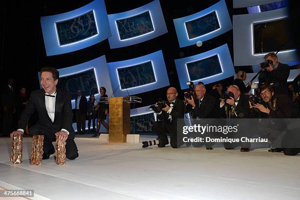 Guillaume Gallienne holds four winning Cesar awards on stage during the 39th Cesar Film Awards 2014 at Theatre du Chatelet on February 28, 2014 in...