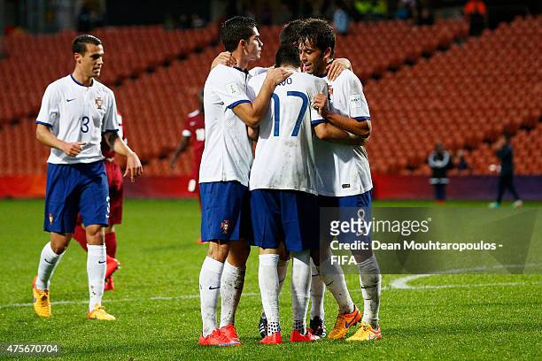 Ivo Rodrigues of Portugal celebrates with team mates after shoots and scores an overhead or bicycle kick for the second goal of the game during the...