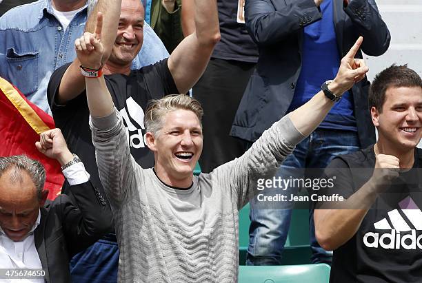 Bastian Schweinsteiger of Bayern Munchen celebrates the victory of his girlfriend Ana Ivanovic of Serbia during day 10 of the French Open 2015 at...