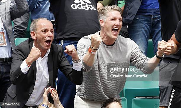 Bastian Schweinsteiger of Bayern Munchen celebrates the victory of his girlfriend Ana Ivanovic of Serbia during day 10 of the French Open 2015 at...