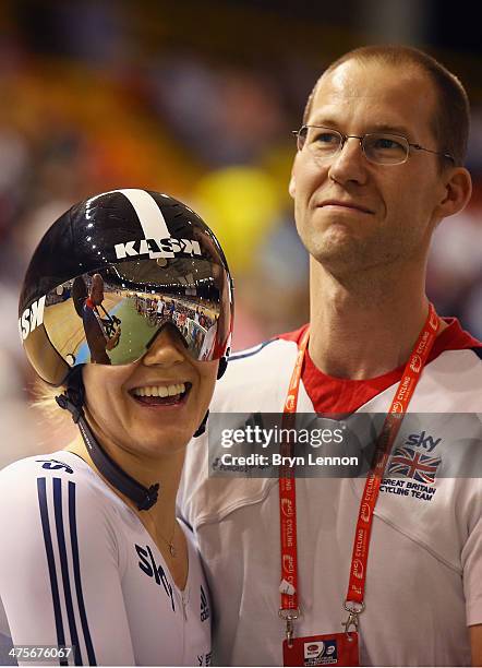 Jessica Varnish of Great Britain and Sprint Coach Iain Dyer react to winning a round of the Women's Sprint during day three of the 2014 UCI Track...