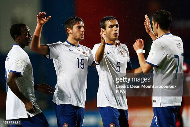 Joao Vigario of Portugal celebrates after he shoots and scores the fourth goal of the game with team mates Ivo Rodrigues, Tomas Podstawski and Janio...