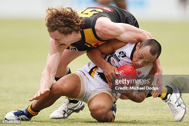 Ben Brown of the Tigers tackles Alex Woodward of the Hawks during the Werribee Tigers v Box Hill Hawks VFL practice match at Aegis Park on March 1,...
