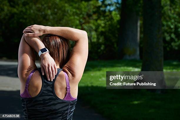 Detail of a woman in sportswear stretching while modelling an Apple Watch Sport, taken on May 21, 2015.