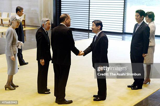 Philippine President Benigno Aquino shakes hands with Crown Prince Naruhito watched by Emperor Akihito , Empress Michiko , Japanese Prime Minister...