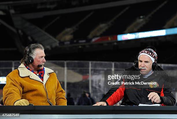 Head coach Joel Quenneville of the Chicago Blackhawks talks with NHL Network host Barry Melrose during the 2014 NHL Stadium Series practice day on...
