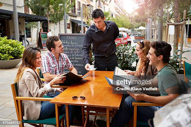 waiter serving coffee for guests outside - pavement cafe imagens e fotografias de stock