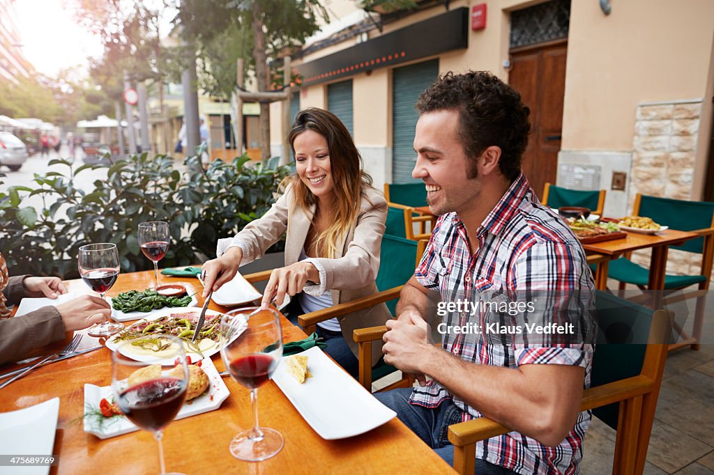 Couples sharing food at restaurant