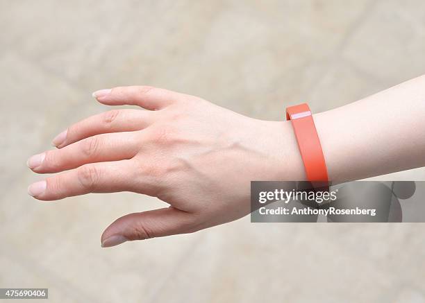 woman wearing a fitbit flex - fitbit stock pictures, royalty-free photos & images