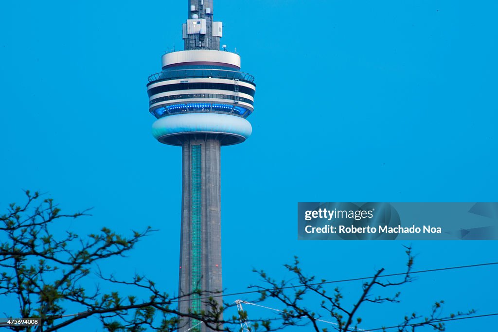 Toronto landmarks: Close up of main part of CN Tower in blue...