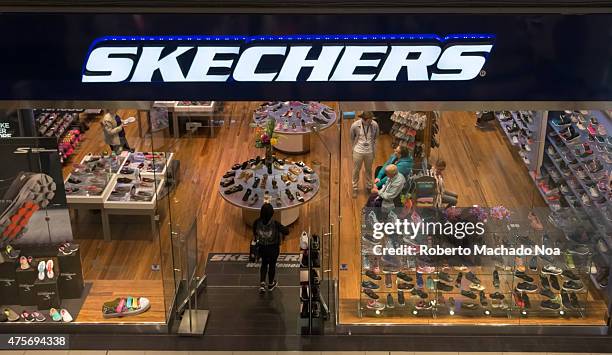 Woman enters Skechers shoe store looking for a good deal.