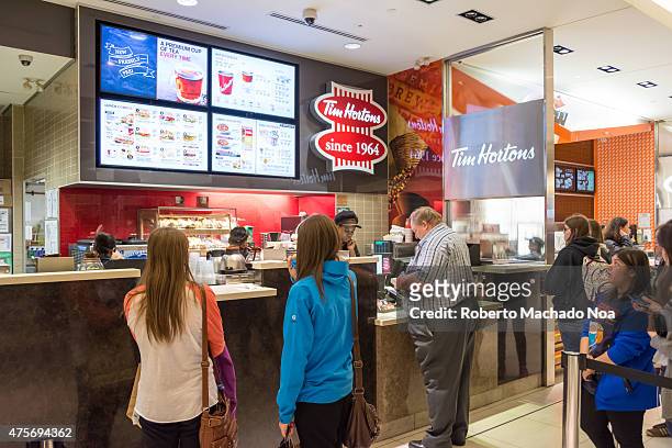 Tim Hortons customers line up to order delicious tea, coffee and other treats.