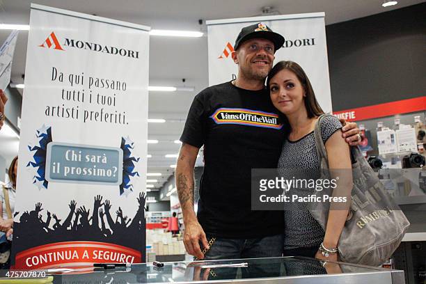 The Italian singer Max Pezzali , former leader of the group 883, poses with his fan during his signing of copies of his latest album "Spaceship Max"...