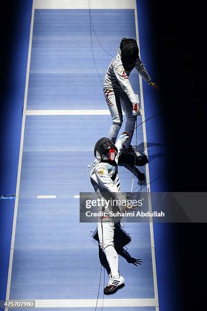 Rihandini Verdiana of Indonesia competes against Wong Mae Hui Shan Nicole of Singapore during the women's individual foil round of 16 at OCBC Arena...