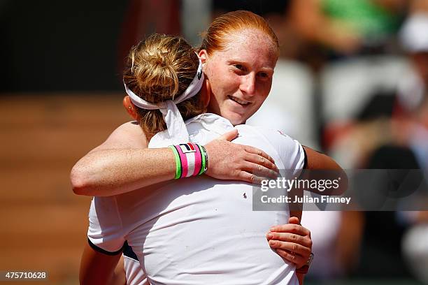 Alison Van Uytvanck of Belgium hugs Timea Bacsinszky of Switzerland at the net after defeat in their Women's quarter final match on day eleven of the...