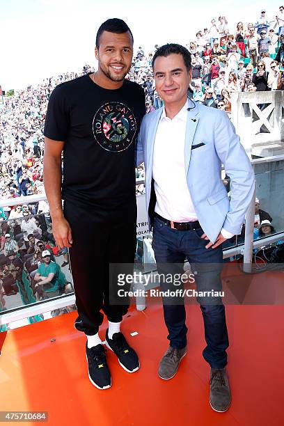 Tennis Player Jo-Wilfried Tsonga and Sports journalist Laurent Luyat pose at France Television french chanel studio during the 2015 Roland Garros...