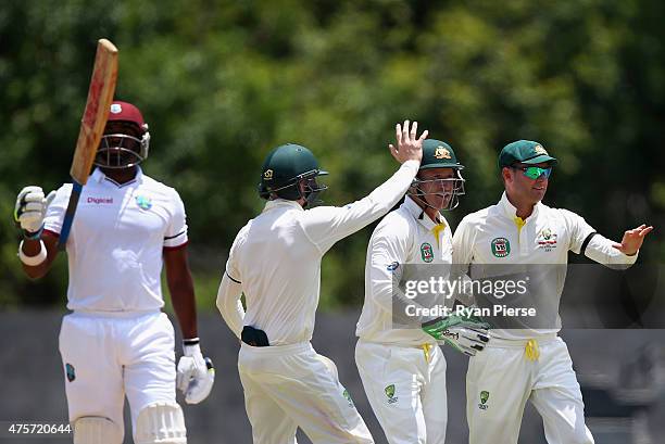 Michael Clarke of Australia celebrates after taking a catch to dismiss Darren Bravo of West Indies off the bowling of Nathan Lyon of Australia during...