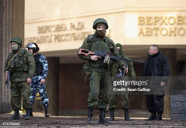 Heavily-armed soldiers without identifying insignia guard the Crimean parliament building after taking up positions there earlier in the day on March...