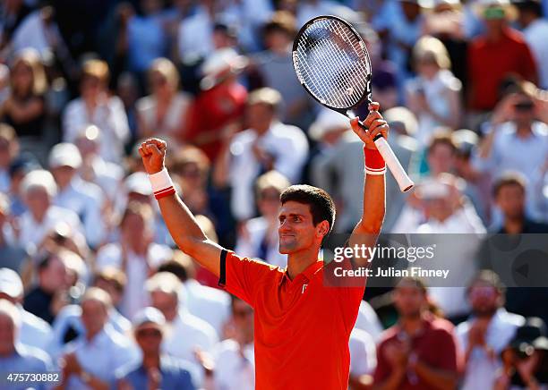 Novak Djokovic of Serbia celebrates victory in his Men's quarter final match against Rafael Nadal of Spain on day eleven of the 2015 French Open at...