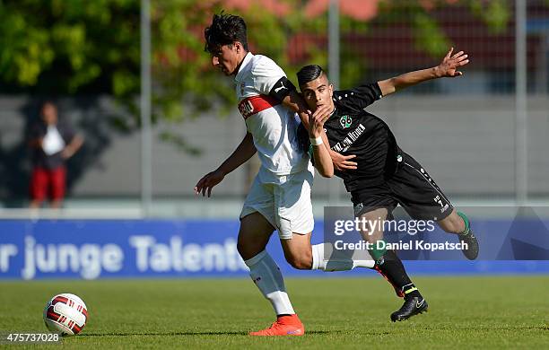 Berkay Oezcan of Stuttgart is challenged by Mete Kaan Demir of Hannover during the B-Juniors Bundesliga semi final match between U17 VfB Stuttgart...