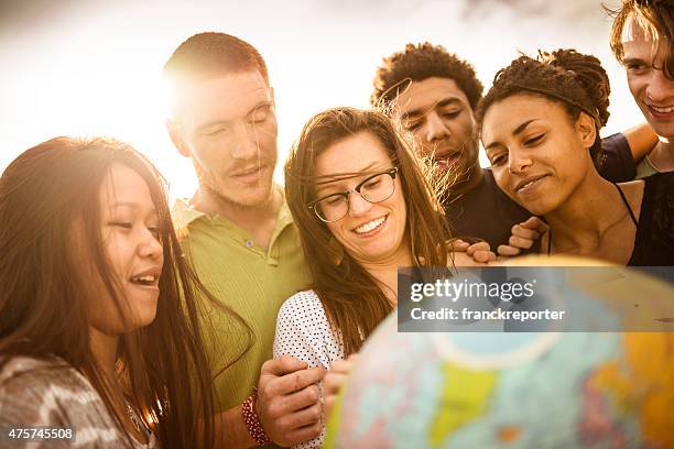 teenagers college student smiling with globe - world hands stock pictures, royalty-free photos & images