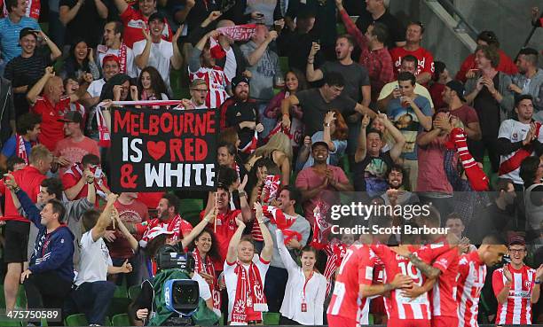 Heart fans in the crowd celebrate as David Williams of the Heart is congratulated by his teammates after scoring a goal during the round 21 A-League...