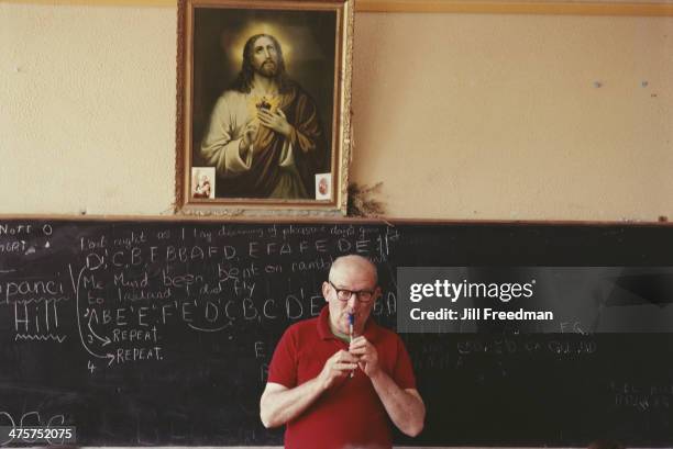 Irish musician Micho Russell gives a lesson on his tin whistle at a school in Ireland, 1984.