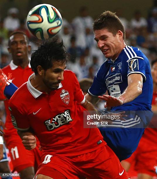 Dubai's al-Nasr Renan Garcia fights for the ball with UAE's al-Ahli Habib Fardan Abdulla Fardan Al Fardan during the football final of the United...