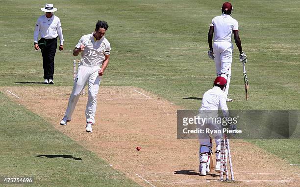 Mitchell Johnson of Australia celebrates after bowling Denesh Ramdin of West Indies during day one of the First Test match between Australia and the...