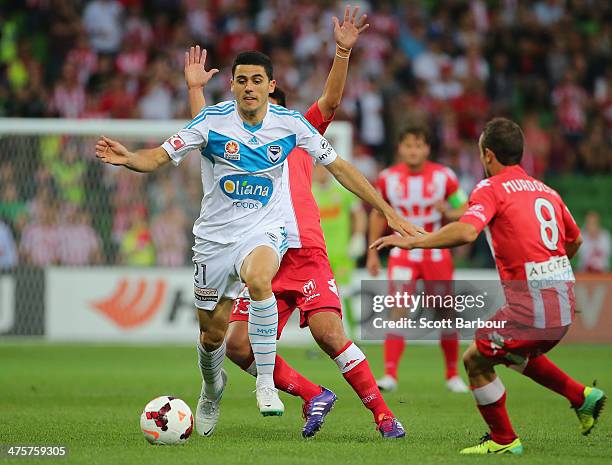 Tom Rogic of the Victory and Jonatan Germano of the Heart compete for the ball during the round 21 A-League match between Melbourne Heart and...