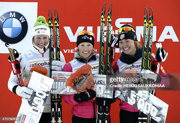Winner US Kikkan Randall , 2nd placed Katja Visnar of Slovenia and 3rd placed Sophie Caldwell celebrate on the podium after competing in the Women's...