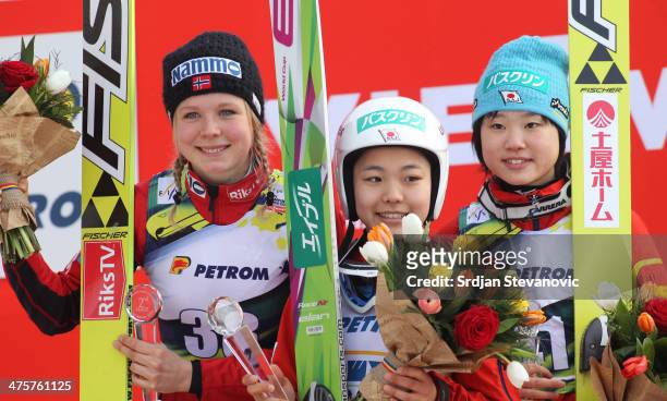 Second place Maren Lundby of Norway, first place Sara Takanashi of Japan and third place Yuki Ito of Japan celebrate on the podium during medal...