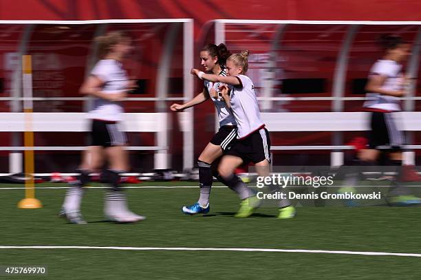 Sara Daebritz and Leonie Maier of Germany practice during an afternoon training session at Algonquin College Soccer Complex on June 3, 2015 in...