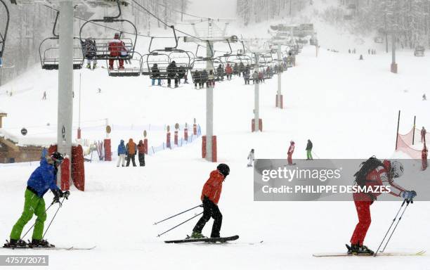 People enjoy a slope in the French Alps Val d'Isere ski resort, on March 1, 2014. The ski area of Val d'Isère and Tignes forms the Espace Killy,...