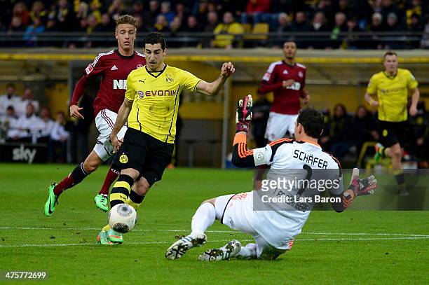 Henrikh Mkhitaryan of Dortmund scores a goal against goalkeeper Raphael Schaefer of Nuernberg, which was disallowed due to the player being offside...