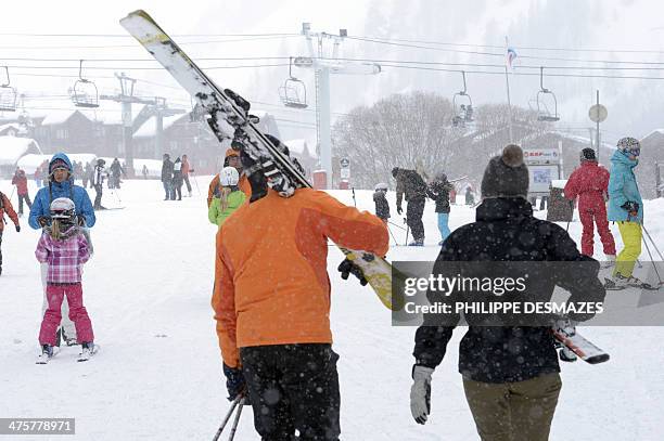 People prepare for skiing at the French Alps Val d'Isere ski resort, on March 1, 2014 during France's school holydays. The ski area of Val d'Isère...
