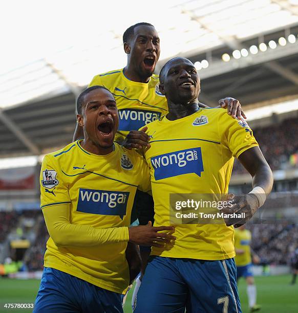 Moussa Sissoko of Newcastle United celebrates with Loic Remy after scoring their third goal during the Barclays Premier League match between Hull...