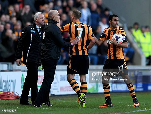 Fourth official Howard Webb restrains David Meyler of Hull City after a clash with Alan Pardew manager of Newcastle United during the Barclays...