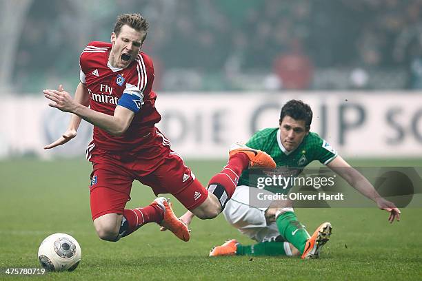 Zlatko Junuzovic of Bremen and Marcell Jansen of Hamburg compete for the ball during the Bundesliga match between Werder Bremen and Hamburger SV at...