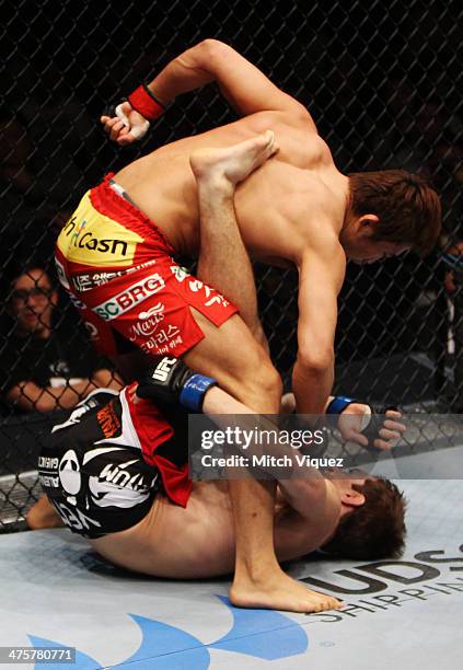 Dong Hyun Kim unleashes punches on John Hathaway in their welterweight fight during the UFC Fight Night event at the Venetian Macau on March 1, 2014...