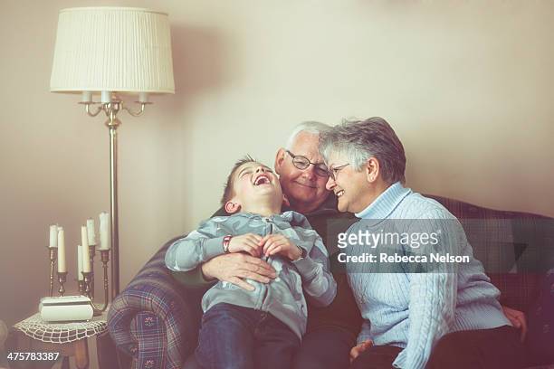 grandparents and grandson sharing a laugh - grandparent stockfoto's en -beelden