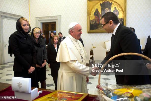 Pope Francis exchanges gift with Romanian Prime Minister Victor Ponta and his wife Daciana Sarbu and his delegation in an audience at the Palazzo...