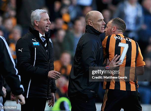 Fourth official Howard Webb restrains David Meyler of Hull City after a clash with Alan Pardew manager of Newcastle United during the Barclays...