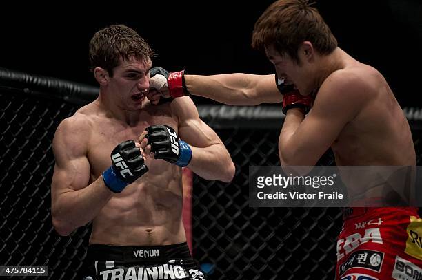 Dong Hyun Kim of South Korea and John Hathaway of England fight in their welterweight bout during the UFC Fight Night at the Cotai Arena on March 1,...