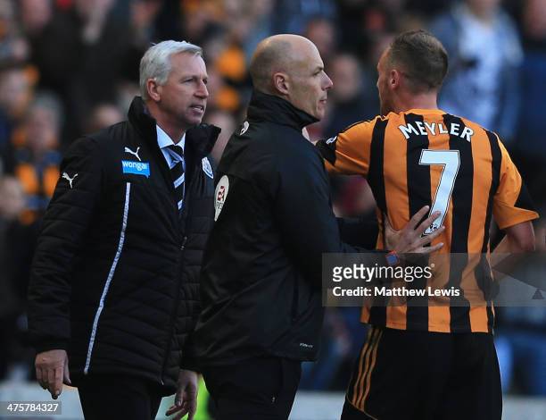 Fourth official Howard Webb restrains David Meyler of Hull City after a clash with Alan Pardew manager of Newcastle United during the Barclays...